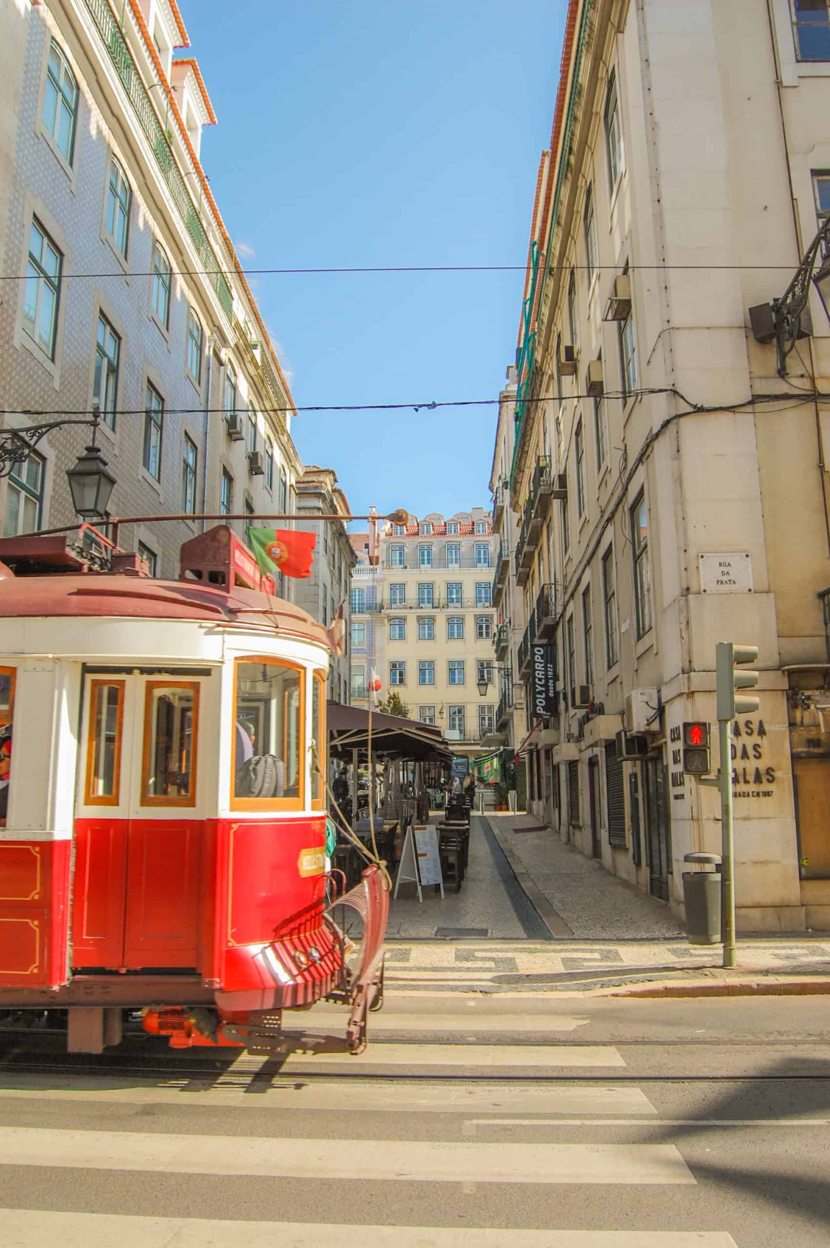 Walking in Lisbon with red tram